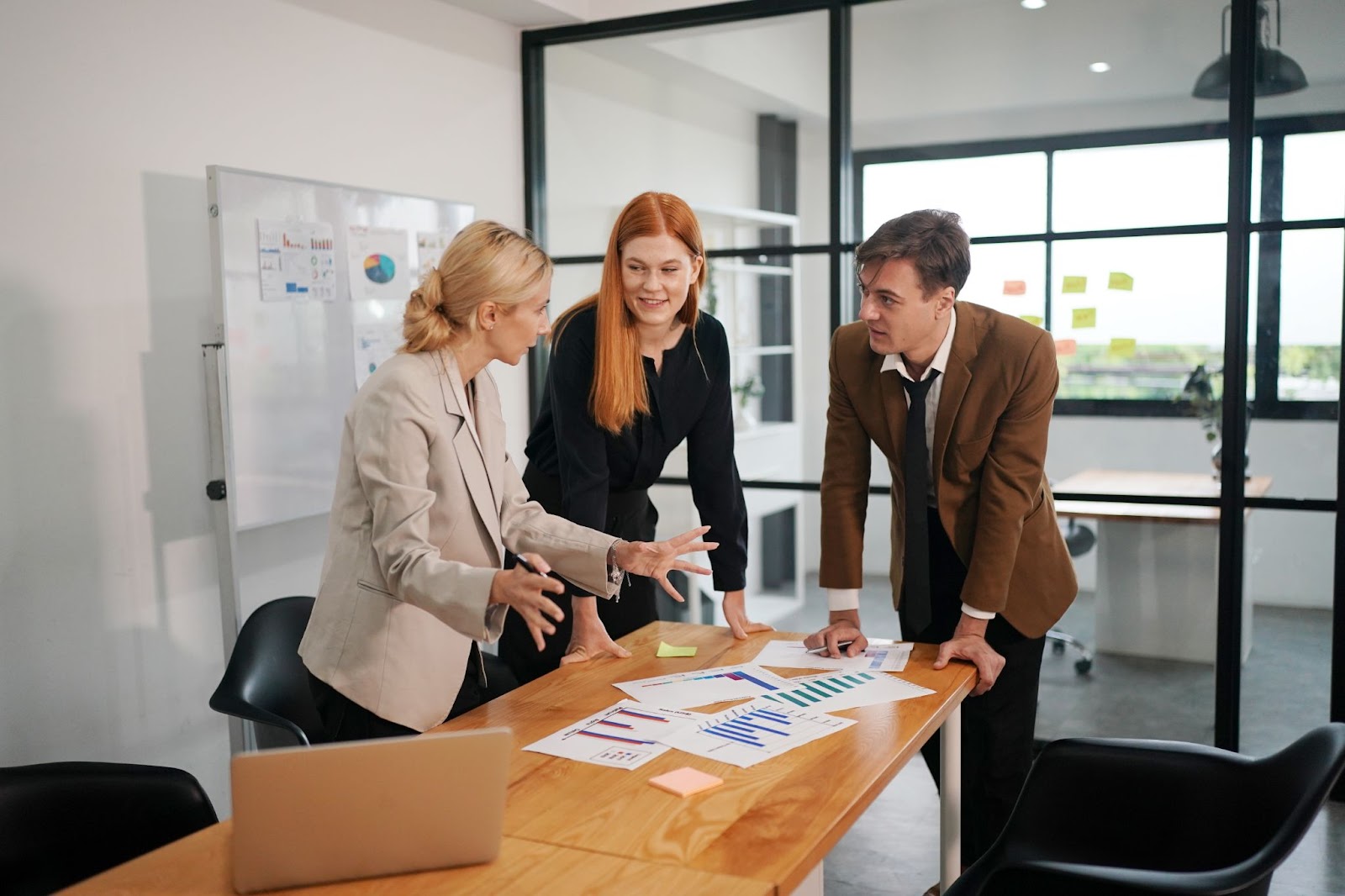 Three young professionals are discussing improving business.