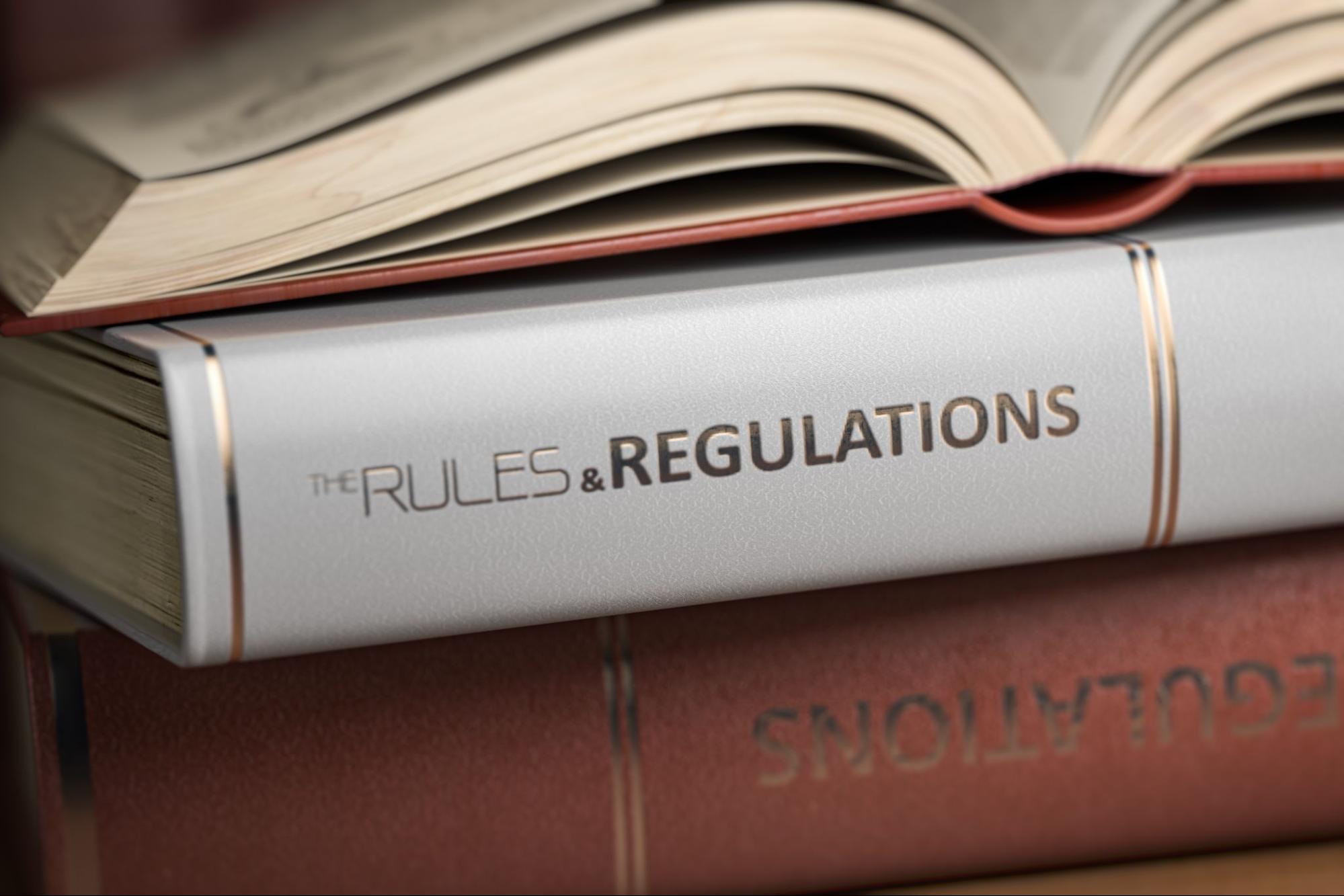 Book with a spine that reads “the rules and regulations.”